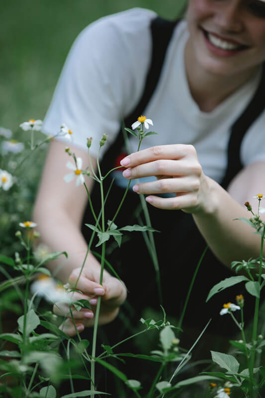Woman picking flowers, Chronic Illness & Injuries Therapy, Boone, NC